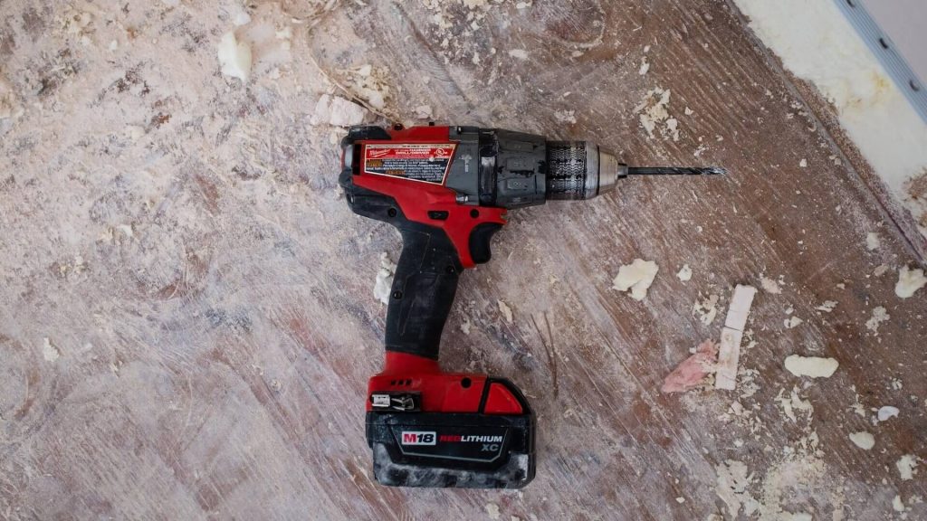 A power drill, a motorized tool used for drilling holes and driving screws.