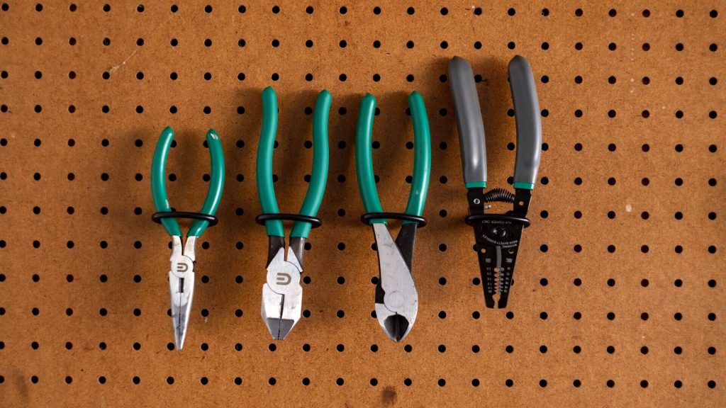 A collection of four different types of pliers, designed for gripping and manipulating objects.