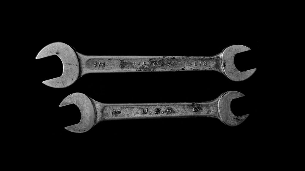 A pair of wrenches, commonly used for tightening or loosening nuts and bolts.